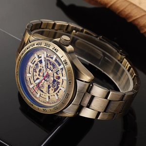 Detailed close-up of a bronze automatic mechanical watch with a skeleton dial and tachymeter
