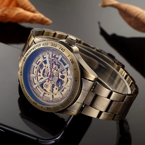 Macro detail of bronze skeleton watch movement with tachymeter scale and polished reflection