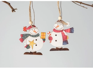 Detail of wooden snowman ornaments with red and blue scarves hanging on a festive branch
