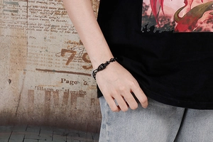 Close-up of black punk skull bracelet made of stainless steel on a male wrist