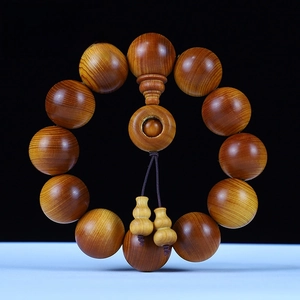 Macro detail of aged red oil cliff cypress beads with 20mm diameter and natural grain