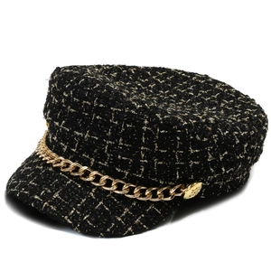 Elegant black tweed baker boy hat featuring metallic gold chain and weave texture