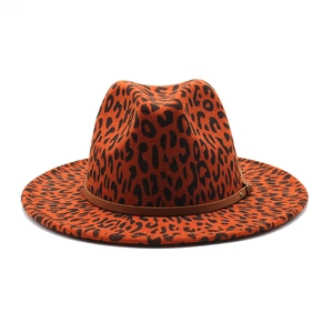 Detail of leopard print fedora hat featuring brown leather band and wide brim