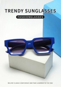 Macro shot of blue square frame sunglasses on stone display with size specs on temple