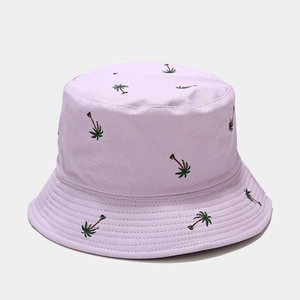 Detailed embroidery of tropical palm trees on a lavender cotton canvas bucket hat