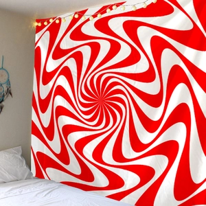 Detailed view of red and white spiral tapestry on bedroom wall with warm string lights