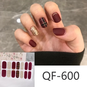 Close-up of QF-600 Christmas nail stickers with red, gold glitter, and plaid designs