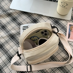 Top view of cream white crossbody bag showing interior storage capacity for essentials
