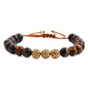 8mm Tiger Eye beaded bracelet featuring three gold crystal-encrusted pave ball accents