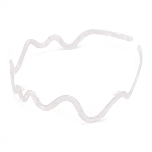 Detail of wavy acetate headband in pearlescent white with non-slip interior teeth