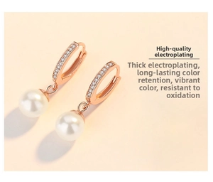 Detailed macro of rose gold pearl earrings with shimmering pavé set white zircon stones
