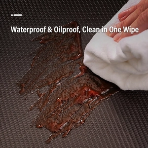Thick waterproof PU leather kitchen mat with anti-slip texture being wiped clean