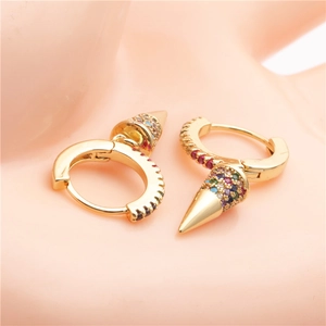 Close-up of gold huggie hoop earrings with colorful zircon-encrusted cone pendants