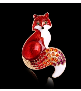 Macro detail of enamel fox brooch with vibrant colorful rhinestones on black background