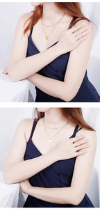 Detail view of gold and silver double-layer round pendant necklaces on snake chains