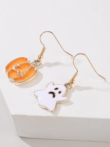 Detail view of asymmetric Halloween pumpkin and ghost earrings on white podium