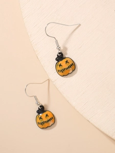 Detailed view of orange pumpkin drop earrings with black accents for Halloween