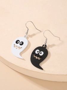 Detail showing cartoon ghost drop earrings in black and white finish on a beige stand