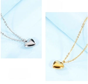 Detailed comparison of gold and silver heart pendant necklaces with a polished mirror finish