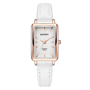 Detail of rose gold rectangular watch case with white dial and premium leather strap