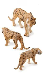 Detailed view of three tiger figurines with realistic orange fur textures and black stripes