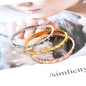 Detail of three-tone honeycomb bracelets with hexagon links and micro-set zircon accents