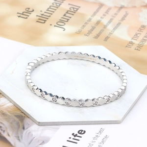 Detail of hexagon honeycomb bracelet with diamonds on marble surface background