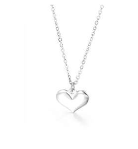 Detailed macro view of high-polish heart pendant on a delicate silver cross chain