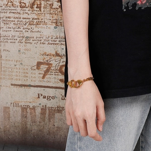 Hip hop style gold Cuban link bracelet with handcuff clasp design on model wrist