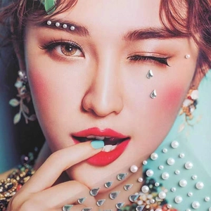 Detailed view of white pearls and teardrop rhinestones applied to the brow and under-eye area