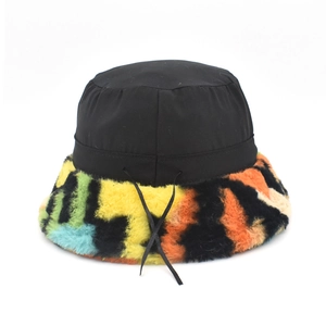 Detailed view of winter bucket hat featuring colorful faux fur brim and black crown texture