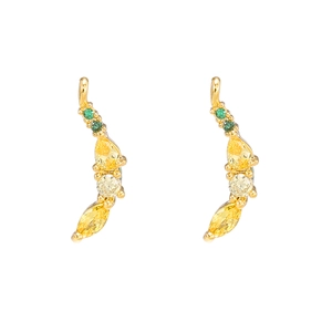 Detail of gold-plated wavy earrings with colorful emerald green and yellow zircon stones