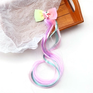 Detail of colorful unicorn hair bow clip with long gradient synthetic hair extensions
