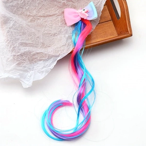 Detail of colorful unicorn hair extensions with a gradient bow for girls' hair styling
