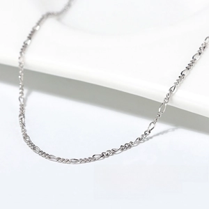 Macro shot of 1.7mm S925 sterling silver Figaro chain with lobster clasp and Italy stamp