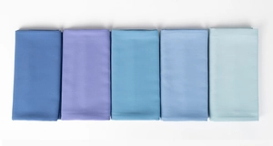 Close-up of pearl chiffon scarves folded in a blue gradient color palette