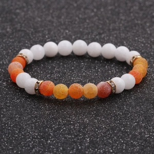 Detail of 8mm white stone and orange dragon vein agate beads with golden spacers