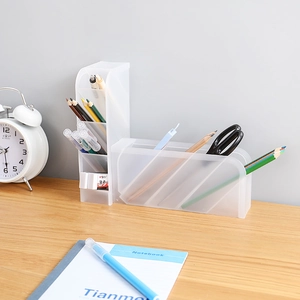 Detail view of transparent desk organizer set for pens and stationery on a wooden table