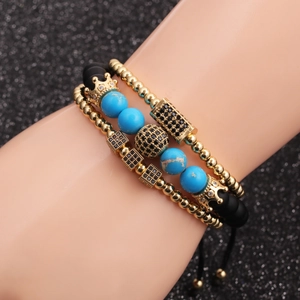 Three-piece turquoise and black beaded bracelet set with golden crown charms and adjustable cord