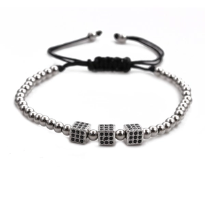 Detail of adjustable black woven bracelet with silver beads and black zircon cubes