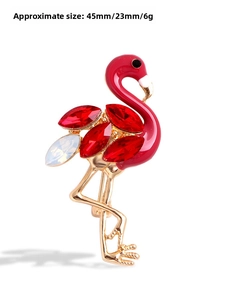 Detailed view of flamingo brooch with red rhinestones and dimensions 45mm by 23mm