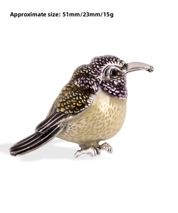 Detail view of bird brooch in silver metal with purple enamel, size 51mm by 23mm