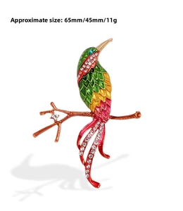 Detail view of bird brooch with colorful enamel and white rhinestones 65mm x 45mm