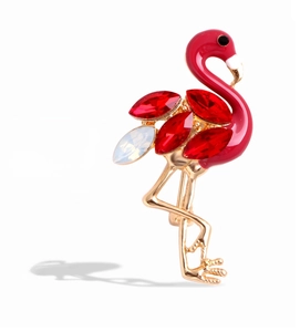 Detailed close-up of flamingo brooch featuring red enamel and sparkling rhinestones