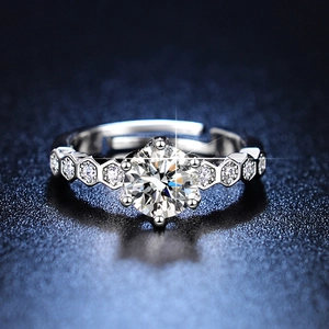 Macro shot of silver adjustable moissanite ring with six-prong setting and side accents