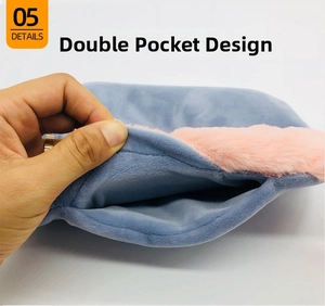 Detail view of the plush hot water bottle cover featuring a dual-pocket hand warmer design