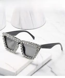 Detail of luxury oversized square sunglasses with sparkling crystals on black frames