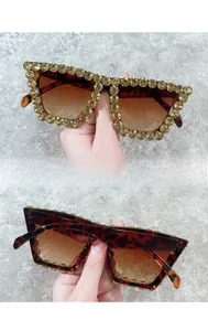 Detail view of oversized tortoise sunglasses with champagne crystals and gradient lenses