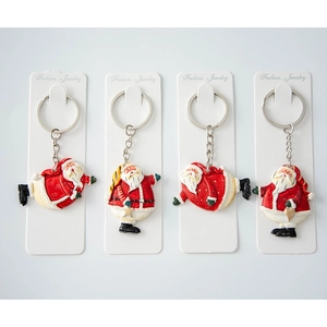 Set of 4 creative Santa Claus resin keychains with red festive metal bag charms
