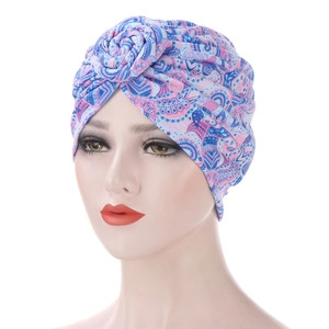 Detail of bohemian floral print turban hat with a spiral twist knot on top
